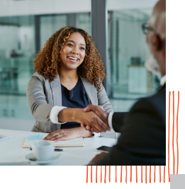 woman shaking hands with someone across a table