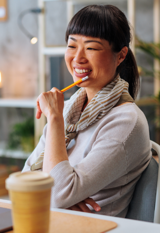smiling woman holding pencil