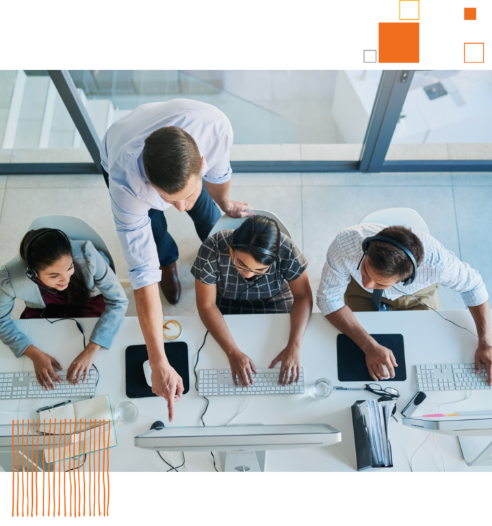 overhead shot of workers looking at computer screen