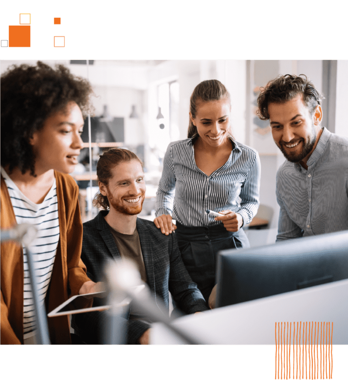 Group of coworkers gathered around computer